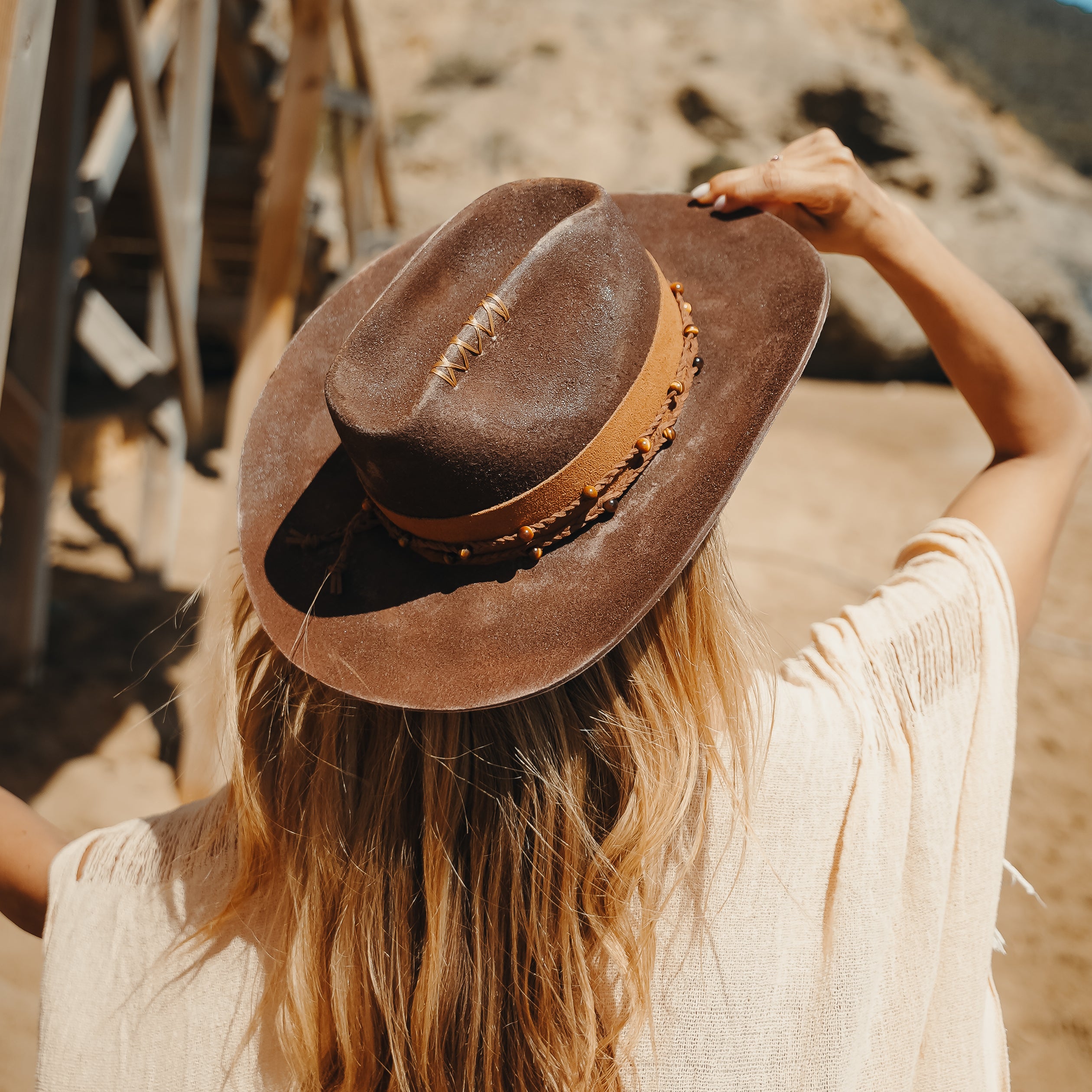 Close-up of Tigers Eye crystal belt on handcrafted cacao brown felt cowboy hat — Satori Collection