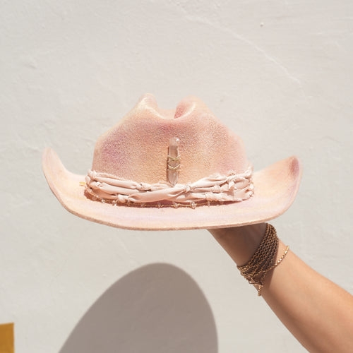 Close-up of Lemurian Quartz point and Clear Quartz crystal detail on handcrafted pink hat — Satori Collection