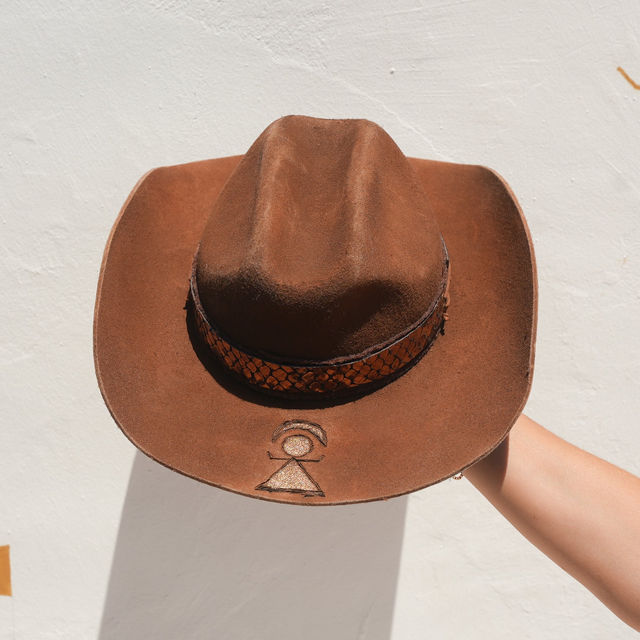 Close-up of Tanit-goddess engraved brim on handcrafted Merino wool felt hat — Satori Collection