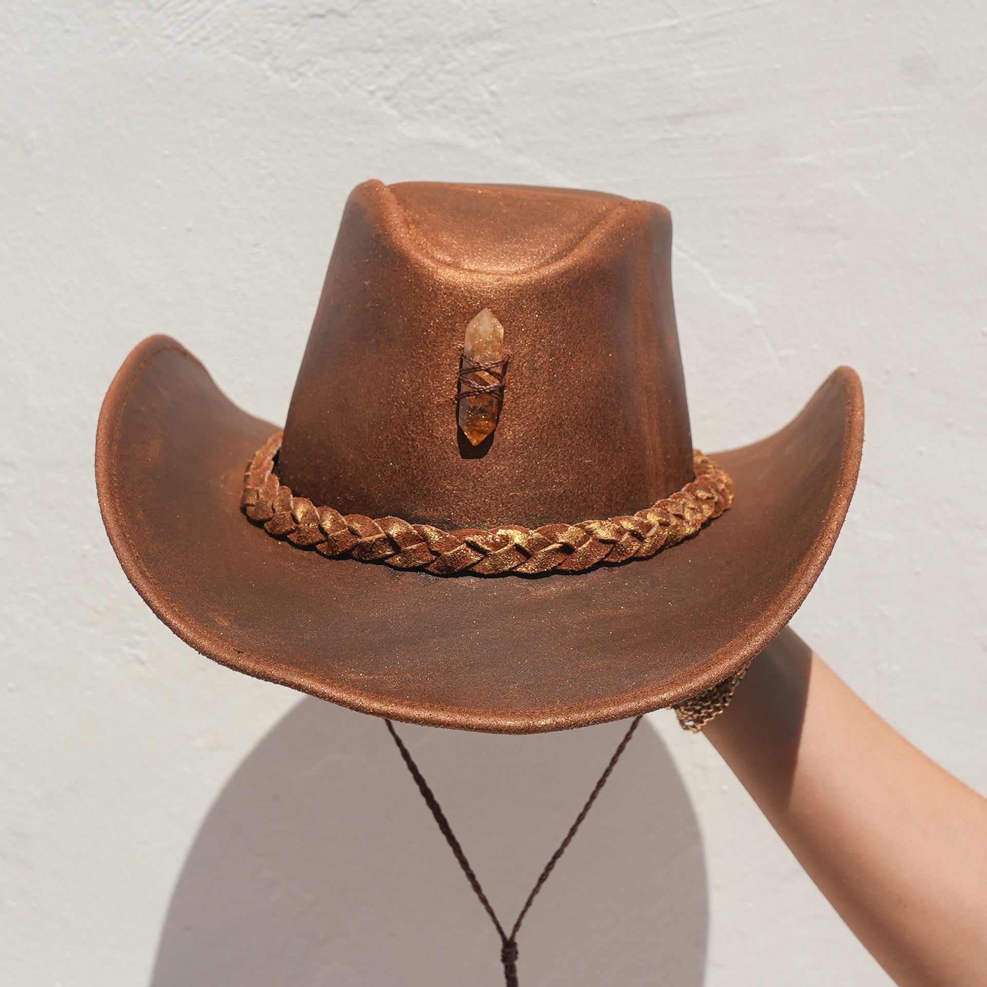 Close-up of Citrine crystal and engraved leather detail on handcrafted Satori hat — Wild Heart