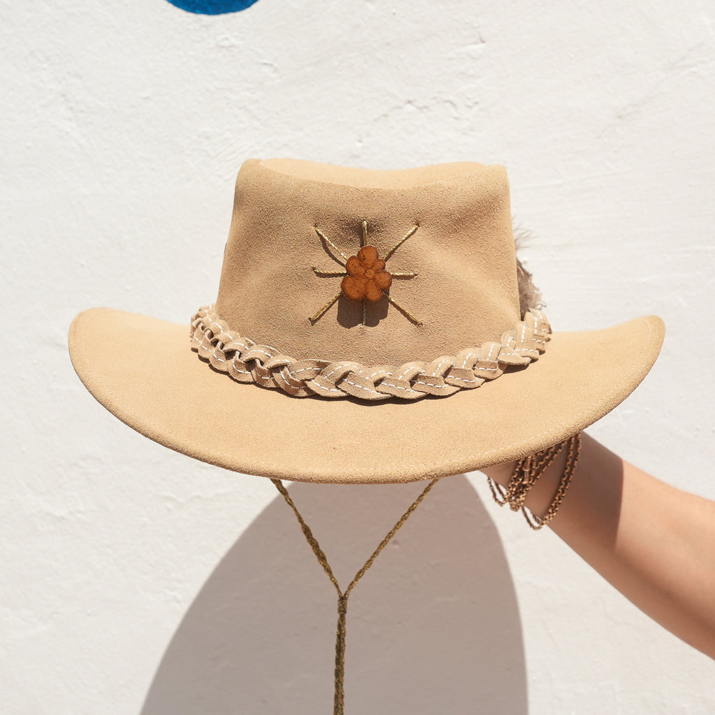 Close-up of Tigers Eye crystal detail on handcrafted beige felt hat — Satori Collection
