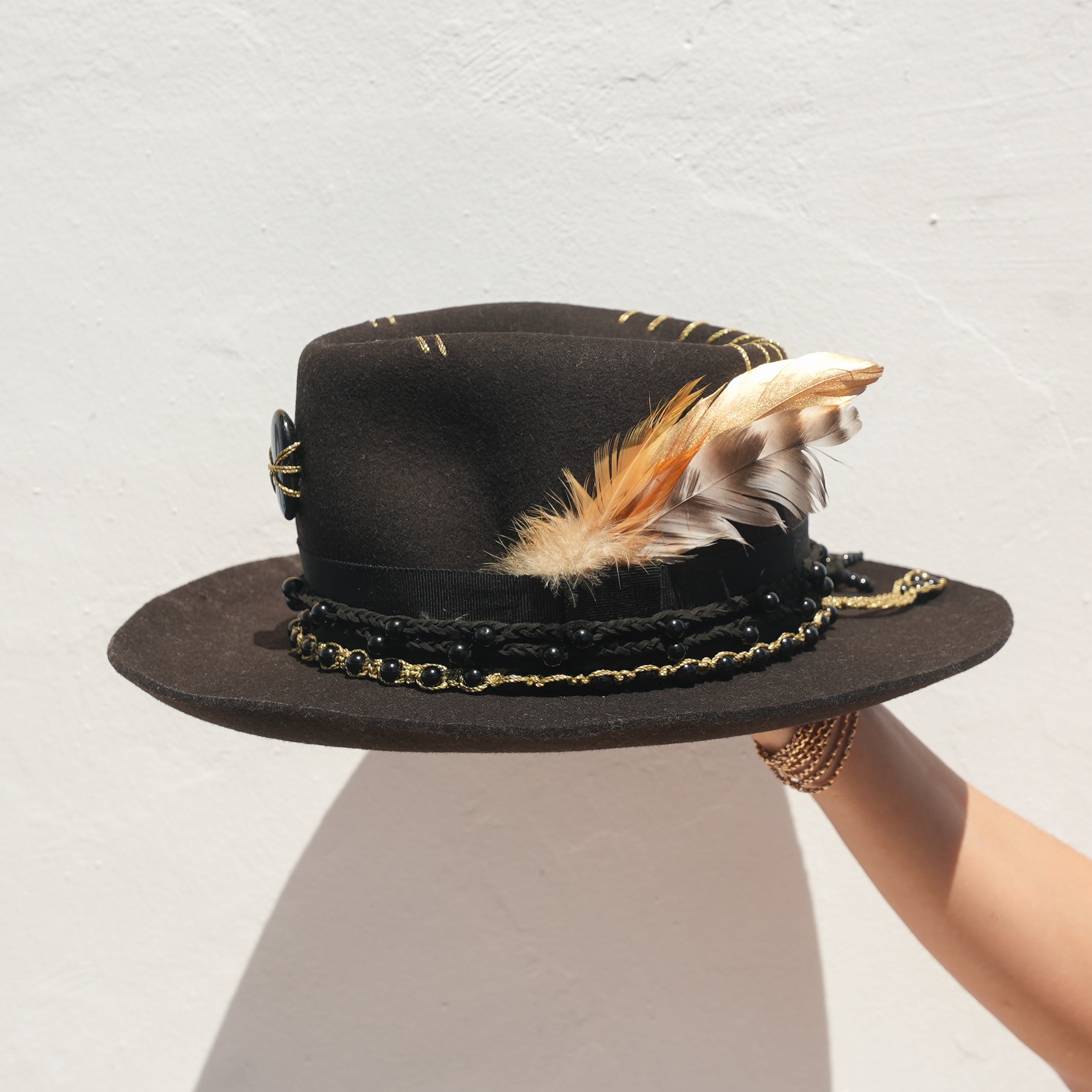 Black Merino wool felt fedora with Obsidian crystal and gold feather detail — Satori Collection Jaguar Rising