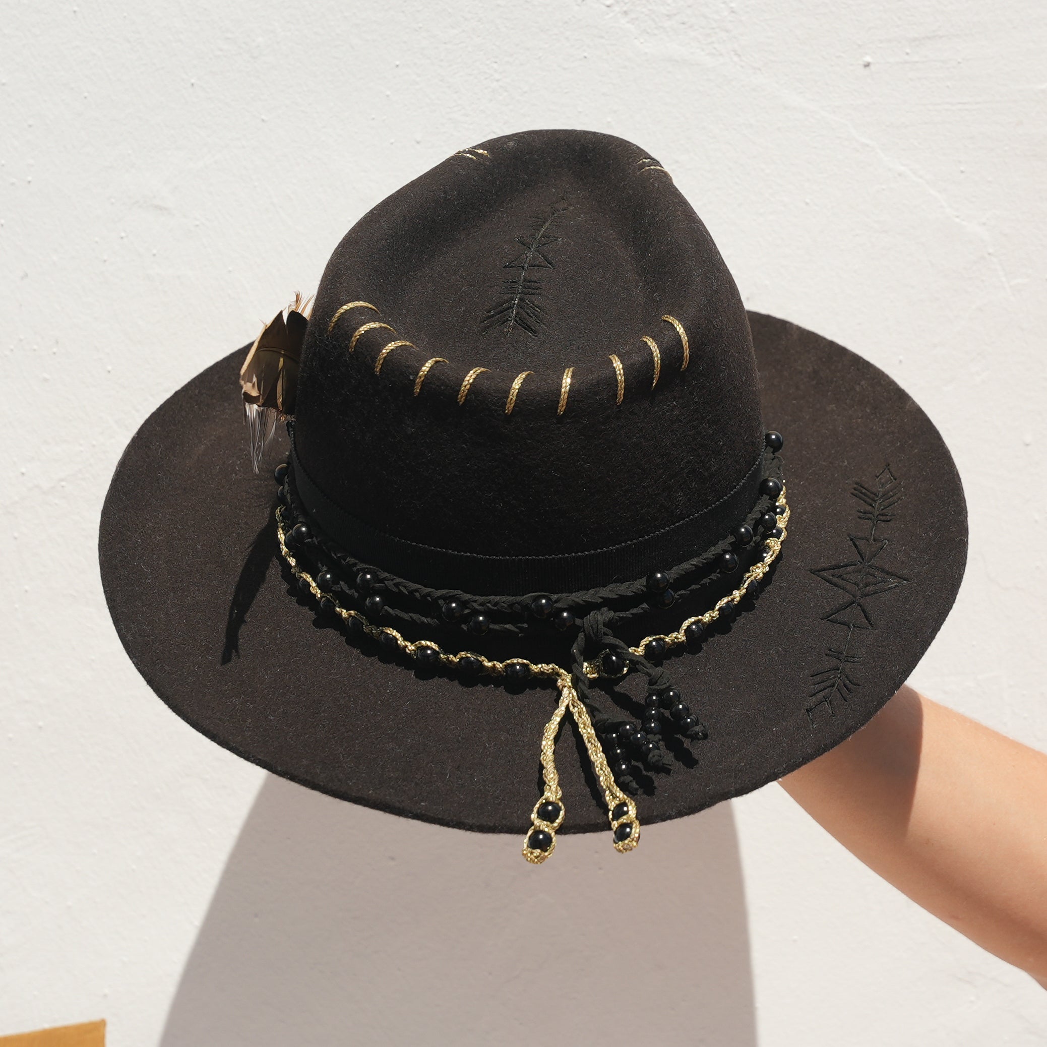 Dark crystal cowboy hat with feather and bead detail — Satori Collection Jaguar Rising