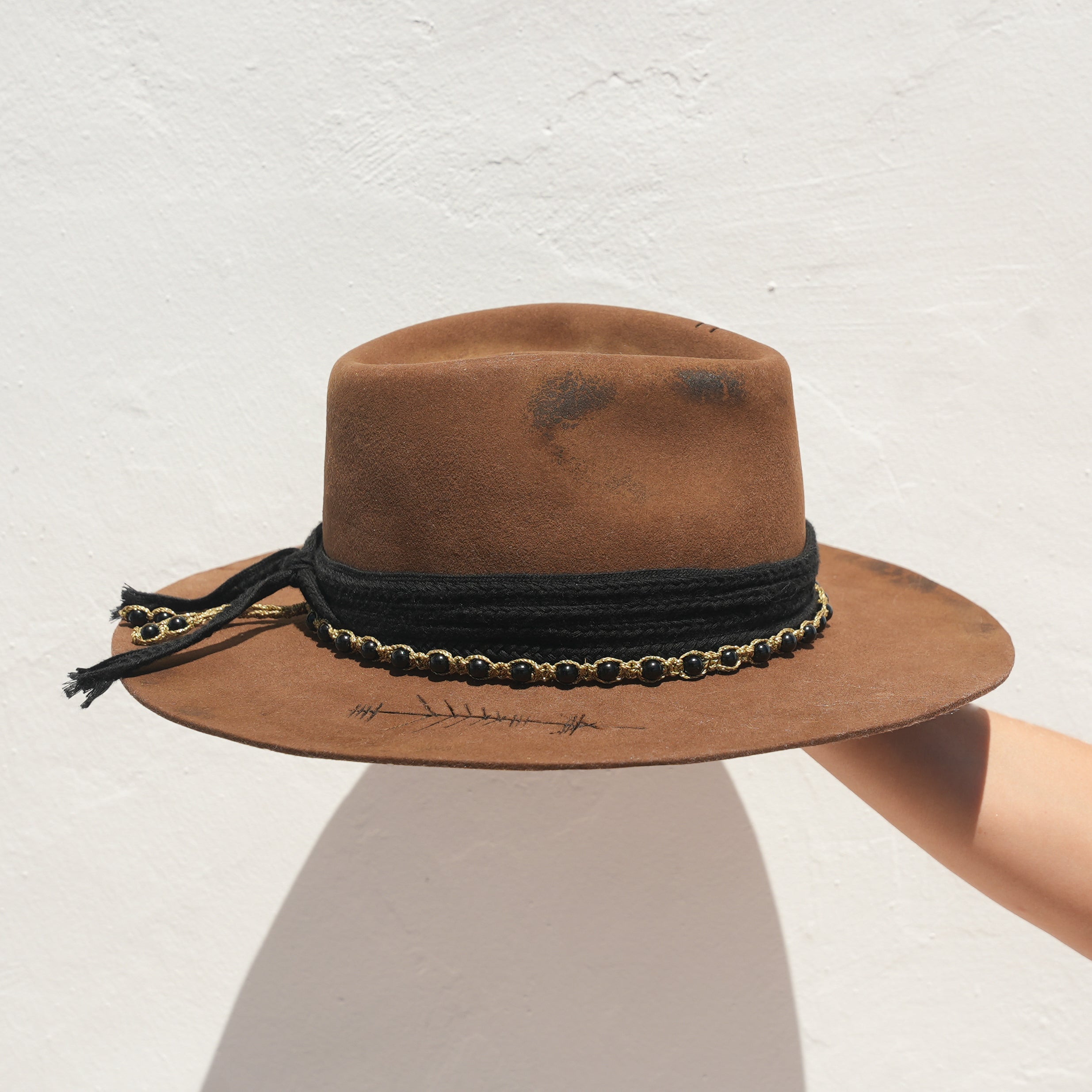 Side profile of handcrafted Merino wool fedora with Obsidian embellishment — Satori Collection Untamed