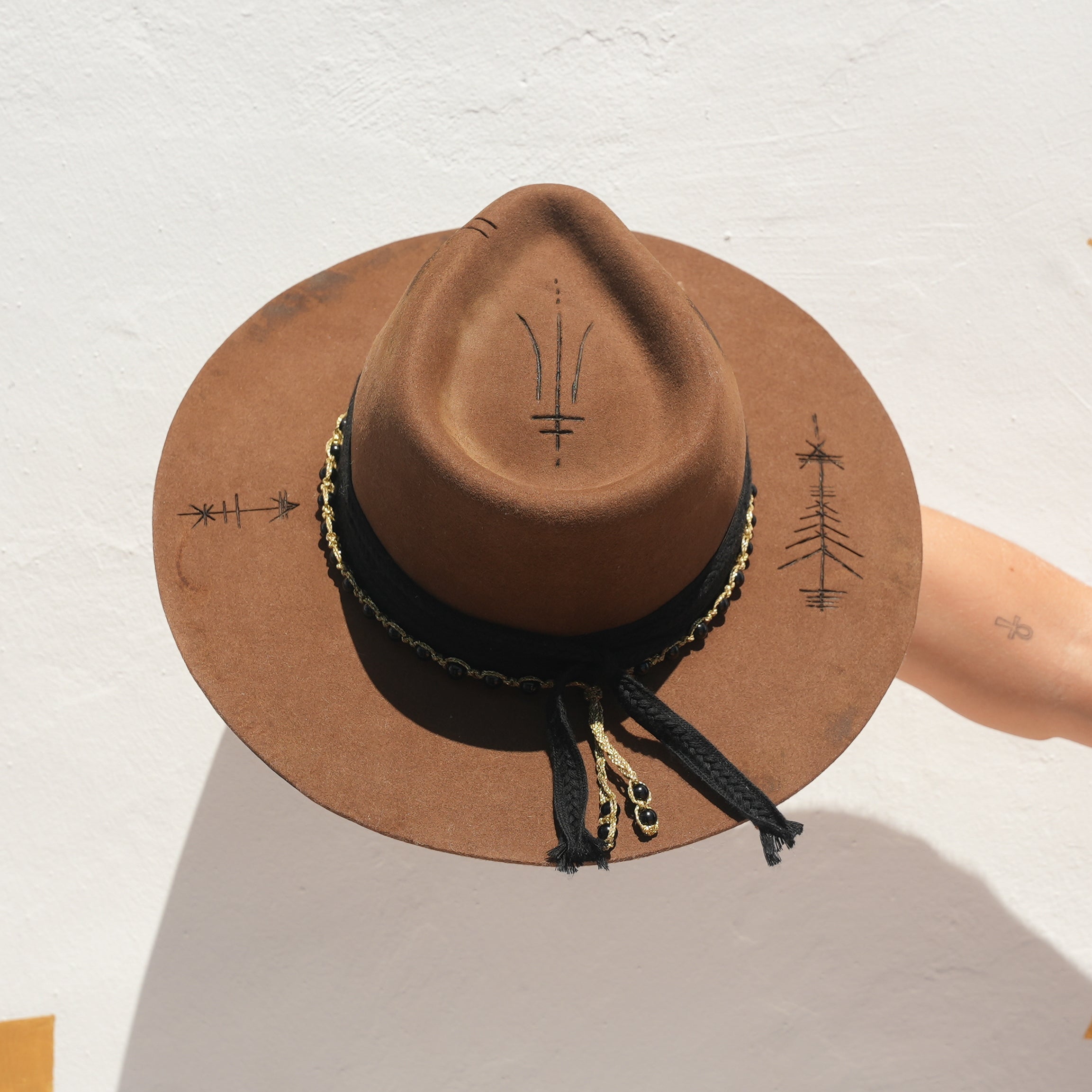 Merino wool felt fedora with Obsidian crystal and gold rope detail worn at festival — Satori Collection Untamed